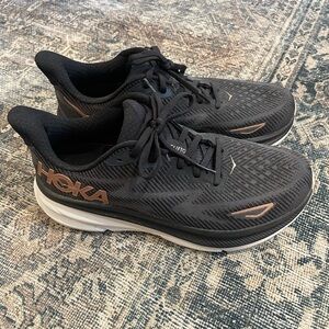 Hoka Women’s Clifton 9 Black and Bronze Athletic Shoes
